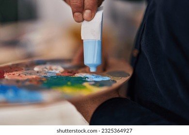 Senior man mixing color on palette at art studio - Powered by Shutterstock