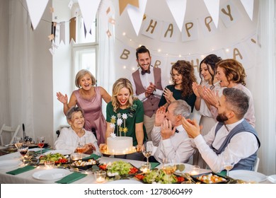 A Senior Man With Multigeneration Family Celebrating Birthday On Indoor Party.