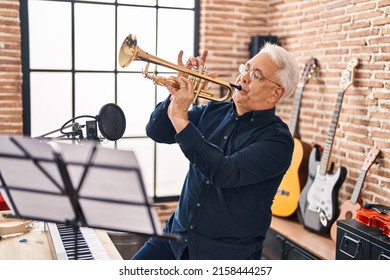 Senior Man Musician Playing Trumpet At Music Studio