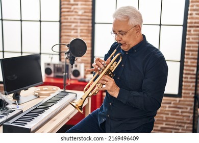 Senior Man Musician Playing Trumpet At Music Studio