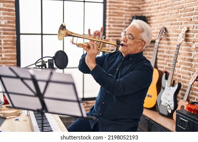 Senior Man Musician Playing Trumpet At Music Studio