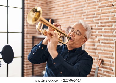 Senior Man Musician Playing Trumpet At Music Studio