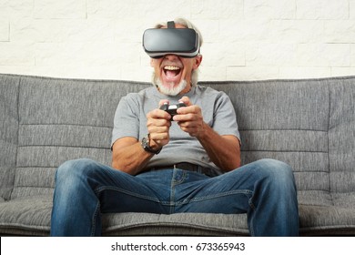 Senior Man On Couch, Playing Vr Game