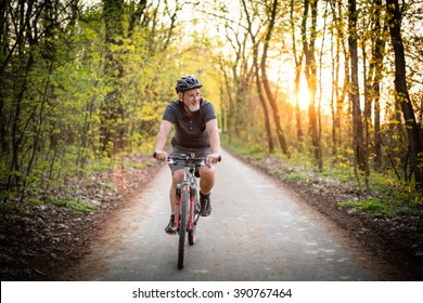 Senior man on his mountain bike outdoors (shallow DOF; color toned image)