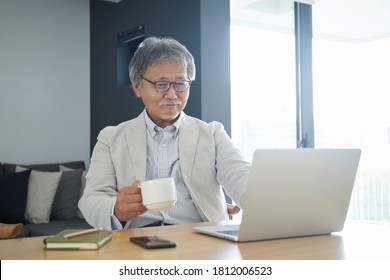 Senior Man Operating A Personal Computer In The Room