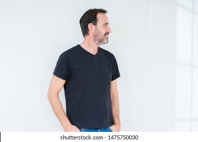 Senior Man Over Isolated Background Looking To Side, Relax Profile Pose With Natural Face With Confident Smile.