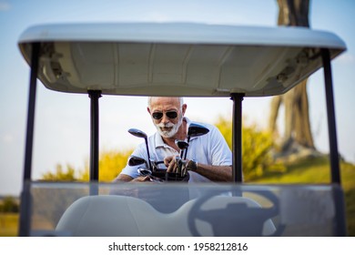 Senior Man Packs For Golf. Golf Car. 