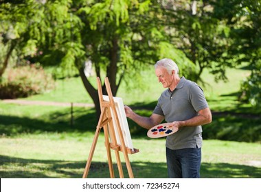 Senior Man Painting In The Garden