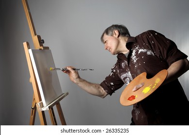 Senior Man Painting On A Canvas