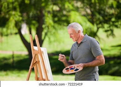 Senior Man Painting Ouside