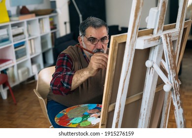 Senior Man Painting The Picture At His Home