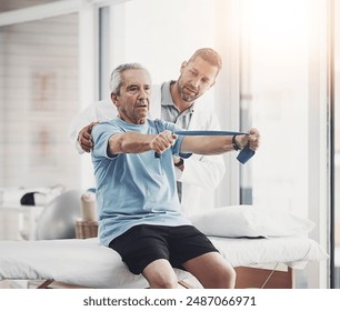 Senior man, physiotherapist and band for resistance training, muscle healing or healthcare clinic. Fitness, physiotherapy and elderly person on bed for mobility exercise, rehabilitation or retirement - Powered by Shutterstock