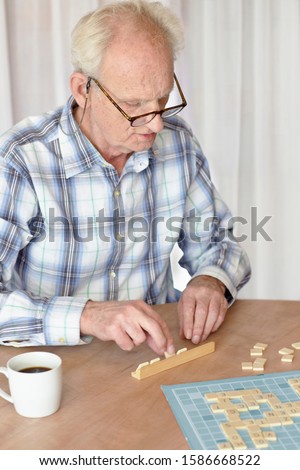 A senior man playing a board game