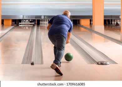 Senior Man Playing Bowling In Club