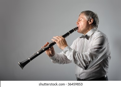 senior man playing clarinet