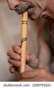 Senior Man Playing The Flute. Faceless Unprofessional Male Of Elderly Caucasian Recorder People With A Moustache With Mouth And Lips Play On Pipe Amateur Music Close Up At Home. Hobbies And Leisure