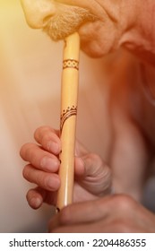 Senior Man Playing The Flute. Faceless Unprofessional Male Of Elderly Caucasian Recorder People With A Moustache With Mouth And Lips Play On Pipe Amateur Music Close Up At Home. Hobbies And Leisure