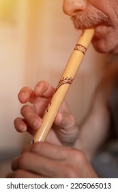 Senior Man Playing The Flute. Faceless Unprofessional Male Of Elderly Caucasian Recorder People With A Moustache With Mouth And Lips Play On Pipe Amateur Music Close Up At Home. Hobbies And Leisure