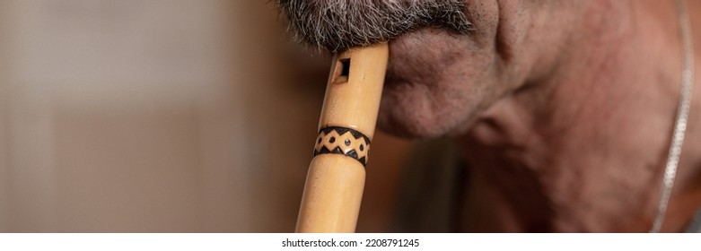 Senior Man Playing Flute. Faceless Unprofessional Male Elderly Caucasian Recorder People With A Moustache With Mouth And Lips Play On Pipe Amateur Music Close Up At Home. Hobbies And Leisure. Banner