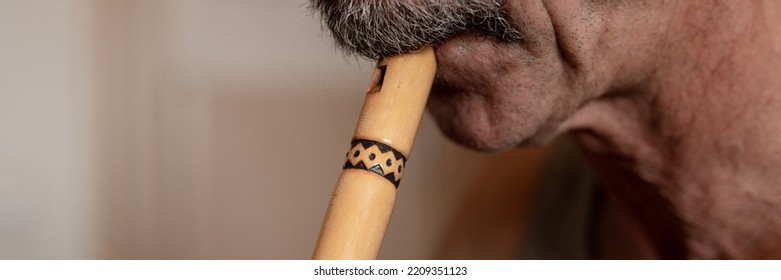 Senior Man Playing Flute. Faceless Unprofessional Male Elderly Caucasian Recorder People With A Moustache With Mouth And Lips Play On Pipe Amateur Music Close Up At Home. Hobbies And Leisure. Banner