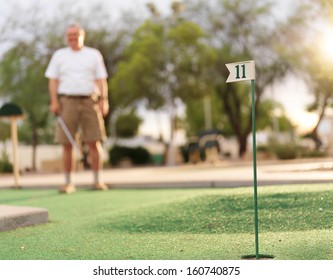 Senior Man Playing Mini Golf