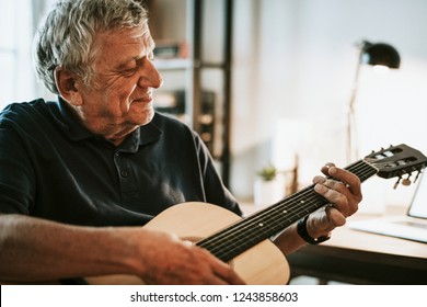 Senior Man Playing On His Guitar