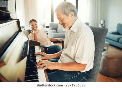 Senior man playing piano for music in living room with wife for bonding, entertainment or having fun. Happy, smile and elderly Asian couple in retirement enjoying keyboard instrument at modern home. - Powered by Shutterstock