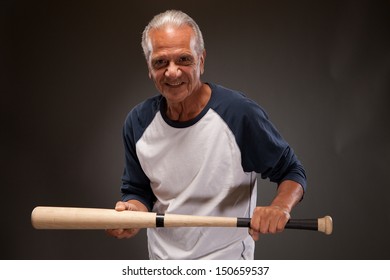 Senior Man Posing With A Baseball Bat 