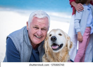 Senior Man Posing With His Dog At The Beach