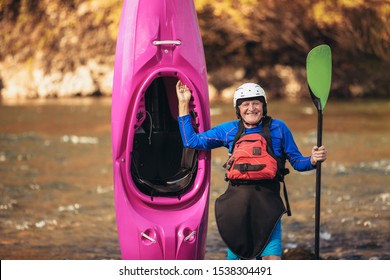 Senior man preparing for kayak tour on a mountain river. - Powered by Shutterstock