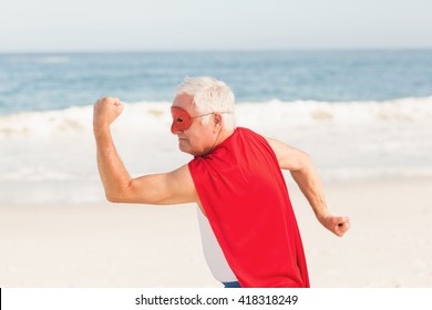 Senior man pretending to be a superhero on a sunny day - Powered by Shutterstock