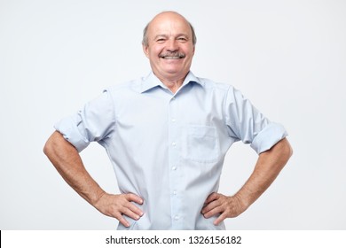 Senior Man With A Proud, Satisfied And Happy Look, With Both Hands On Hips