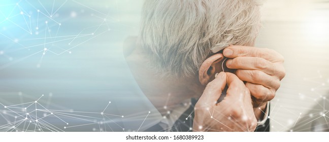 Senior Man Putting Hearing Aids; Panoramic Banner