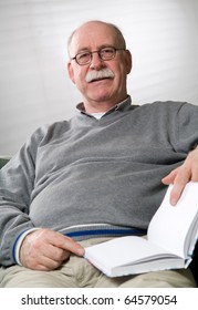 Senior Man Is Reading A Book