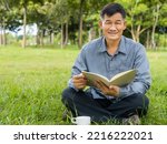 Senior man reading the book and happy drink coffee at the park, lifestyle senior concept
