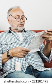 Senior Man Reading Instruction Leaflet