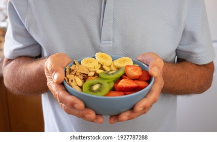 Senior Man Ready To Eat A Salad Of Fresh And Dried Fruits. Breakfast Or Lunch Time, Healthy Eating