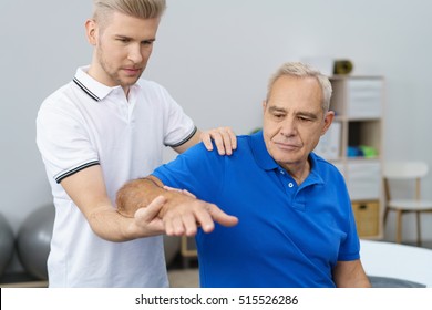 Senior man receiving massage by male physic therapist of his arm due to injury - Powered by Shutterstock