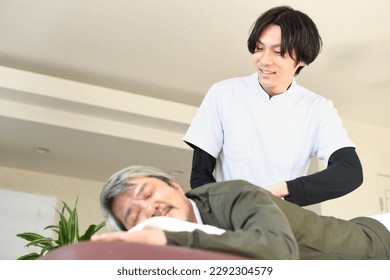 Senior man receiving a massage with a male therapist
 - Powered by Shutterstock