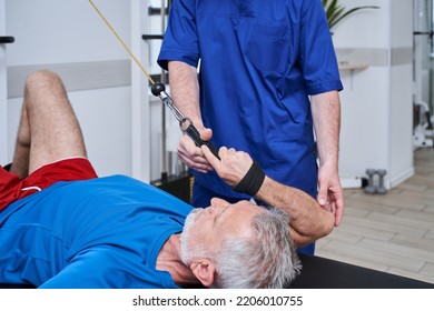Senior man in recovery laying and doing exercises, physiotherapy - Shutterstock ID 2206010755