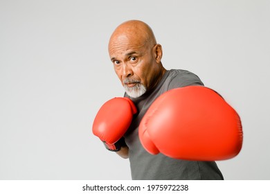 Senior man with red boxing gloves - Powered by Shutterstock