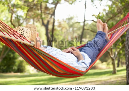 Senior Man Relaxing In Hammock