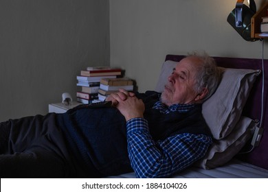 Senior Man Relaxing Or Resting On A Sofa And Watching TV At Late Night