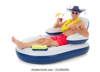 Senior Man Relaxing While Floating In Chair In Swimming Pool