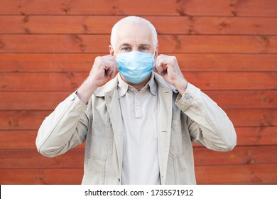 senior man in a respirator to protect against infection with influenza virus or coronavirus - Powered by Shutterstock