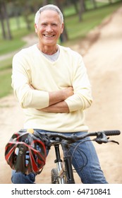 Senior Man Riding Bicycle In Park