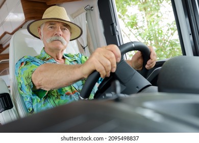 Senior Man Riding Vintage Camper Van