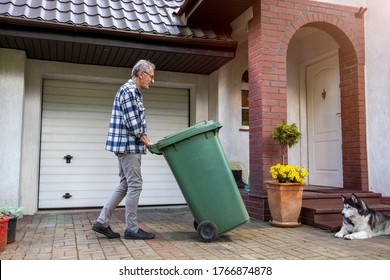 Senior Man Rolling Garbage Can
