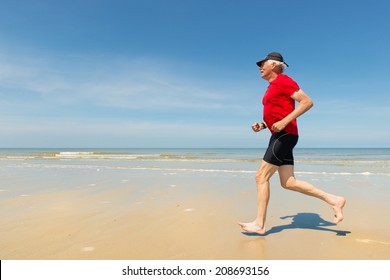 Senior Man Running At The Beach