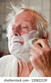 Senior Man Shaving His Beard In Bathroom.